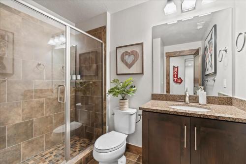a bathroom with a toilet and a shower and a sink at Hideout Haven 4BR 10 min from Deer Valley in Keetley Junction