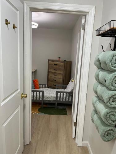 a hallway with a baby crib in a room with towels at The Rene Carr House in Elkton