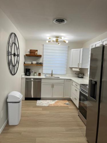 a kitchen with white cabinets and a stainless steel refrigerator at The Rene Carr House in Elkton
