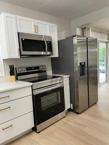 a kitchen with a stainless steel refrigerator and a microwave at The Rene Carr House in Elkton
