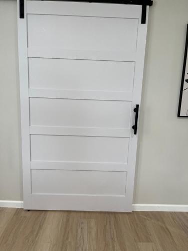 a closet door with white drawers in a room at The Rene Carr House in Elkton