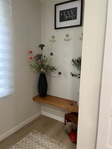 a vase of flowers sitting on a shelf in a room at The Rene Carr House in Elkton