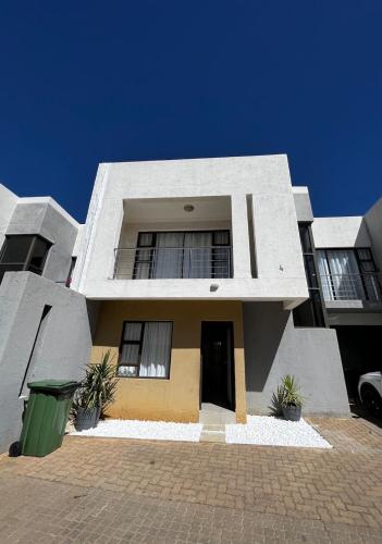 a large house with a driveway in front of it at Haven Hide Self Catering in Windhoek
