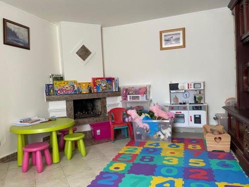 a living room with a table and a fireplace at Chalupa u Marušky 