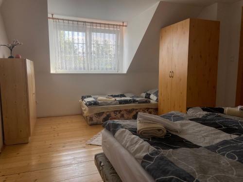 a room with two beds and a window in it at Chalupa u Marušky 
