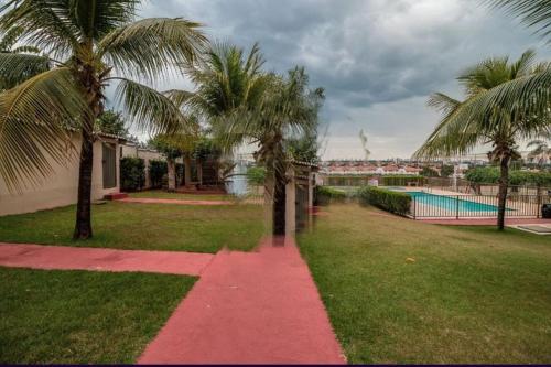 einen Gehweg mit Palmen und einem Pool in der Unterkunft Quarto apê completo , Centro, Damhas e Rodoviária , localização privilegiada in Sao Jose do Rio Preto