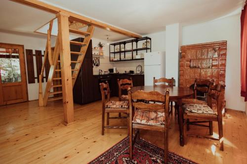 a room with a table and chairs and a kitchen at Cheerful Forest Cabin with Hot Tub! 
