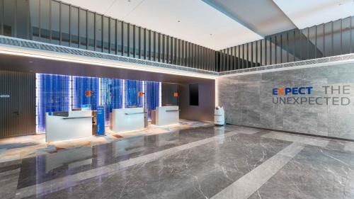 a lobby with a row of urinals in a building at Holiday Inn Express Foshan Shunde Lecong by IHG in Shunde