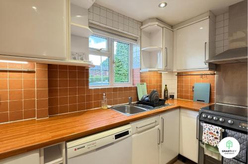 a kitchen with white cabinets and a sink at 4 Bedroom spacious home with parking sleeps 9 in Hurley