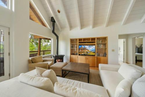 a living room with white furniture and a fireplace at Banner Elk Valley Overlook in Banner Elk