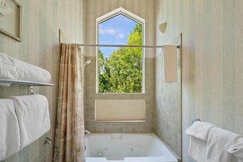 a bathroom with a bath tub and a window at Banner Elk Valley Overlook in Banner Elk