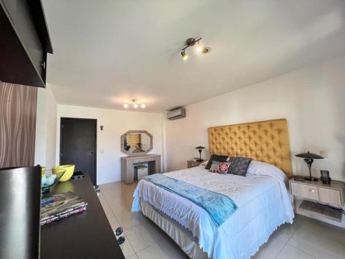 a bedroom with a large bed and a fireplace at Salinas Solutions in Salinas