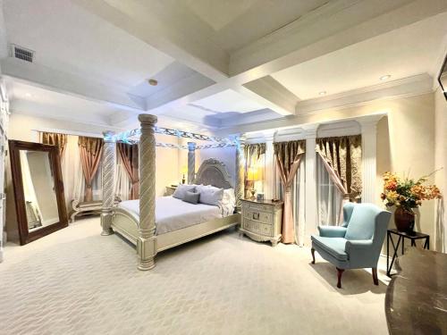 a bedroom with a bed and a blue chair at Temple View Inn with Music Studio in Independence