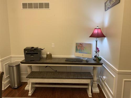 an office with a desk with a computer and a lamp at Temple View Inn with Music Studio in Independence