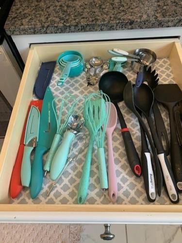 a drawer filled with utensils and spoons at Temple View Inn with Music Studio in Independence