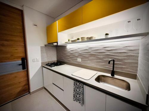 a kitchen with a sink and a counter top at Modern Beach Retreat Luxury Feel in Playa Bello Horizonte
