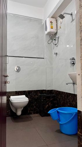 a bathroom with a toilet and a sink at Shri Sai Palace in Udupi