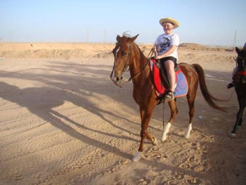 a man riding a horse on the beach at White desert camp in Bawiti