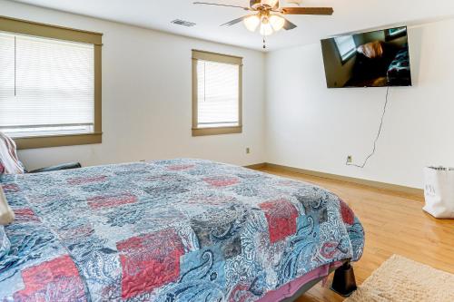 a bedroom with a bed and a ceiling fan at Relaxing Outdoor Spaces Quiet Wooded Gem in Hardy in Hardy