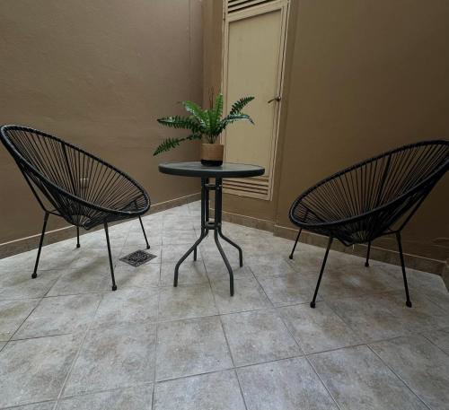 two chairs and a table with a potted plant on it at El lapacho 2 in Santiago del Estero