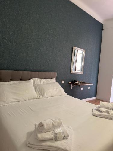 a bedroom with a bed with towels on it at NOI Luxury rooms Colosseum in Rome