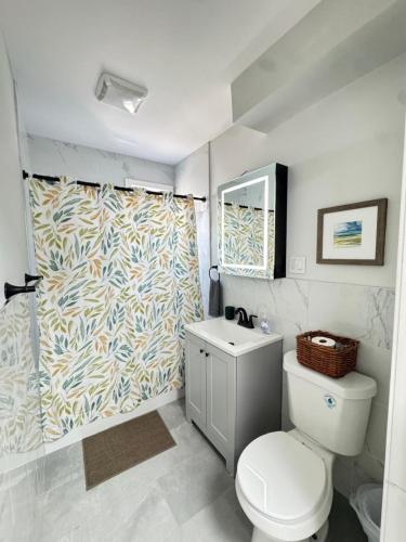 a bathroom with a toilet and a shower curtain at Yale Casa Baya in New Haven