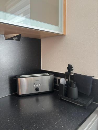 a kitchen counter with a toaster on top of it at Apart Pitzenklamm in Arzl im Pitztal