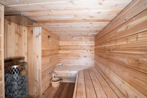 a sauna with wooden walls and a wooden floor at Ghost Peak Chalet - Ski-In Access in Port Mann