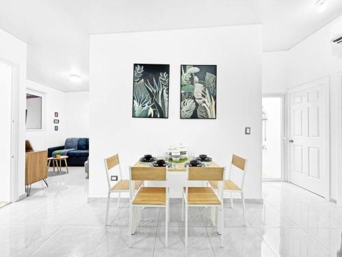 a white dining room with a table and chairs at Casa Volcan 2BR with Pool and Volcano Views in San Miguel