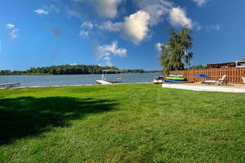 a large grassy area with a view of a lake at 3Bed 2Bath Luxury Lake House on Myers Bay Private Pier Beach Firepit and Deck in Fox Lake
