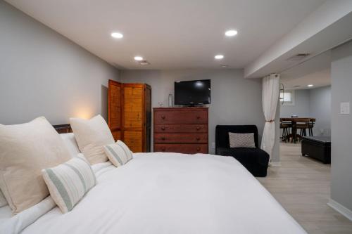 a bedroom with a white bed and a television at 3Bed 2Bath Luxury Lake House on Myers Bay Private Pier Beach Firepit and Deck in Fox Lake