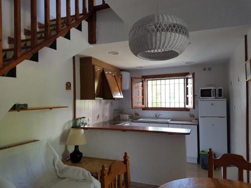 a kitchen with a staircase and a kitchen with a table at Casa Cambrils 500m playa AC in Cambrils