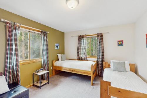 a bedroom with two beds and two windows at Lucky Bear's Lair in Fairplay