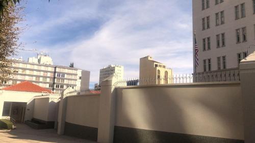 a fence in front of a building with buildings at Confortable and modern, 14th Floor in La Paz