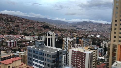 an aerial view of a city with buildings and mountains at Confortable and modern, 14th Floor in La Paz