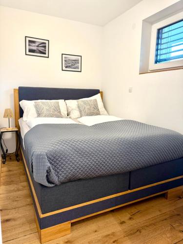 a bed in a bedroom with a blue mattress at Neue und sonnige Doppelhaushälfte in Dobl bei Graz Top 2 in Dobl