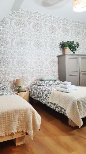 a bedroom with two beds and a wall at Dawno Temu - Agroturystyka Premium in Lipowy Most