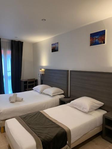 Postelja oz. postelje v sobi nastanitve Hôtel Résidence Châtillon