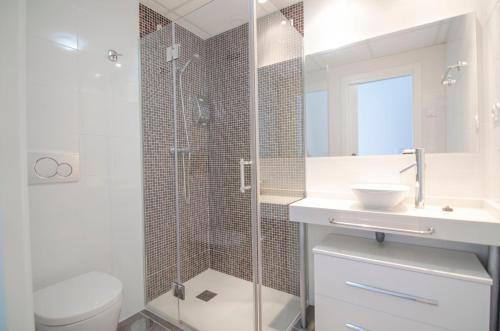 a bathroom with a shower and a sink and a toilet at Sea Senses by Mar Holidays in Torrevieja