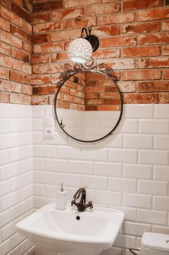 a bathroom with a white sink and a mirror at Uroczysko Oleśnica in Chodzież