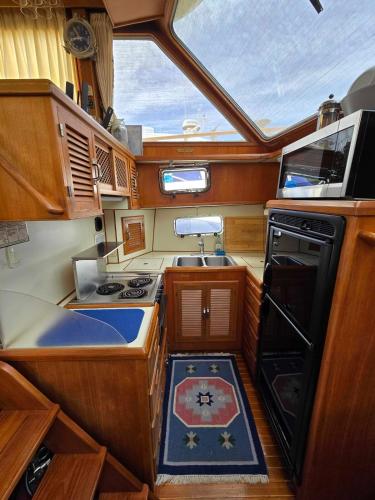 a kitchen in a boat with a stove and a window at Dockside Boat Rental Beach Rosario Pool Ocean View in Eastsound