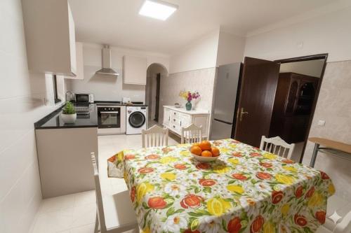 a kitchen with a table with a bowl of fruit on it at Moradia de Campo Isolada com Piscina a 5km da Praia in Alcantarilha