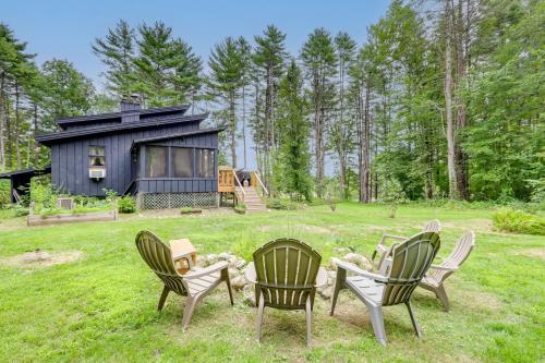 a group of chairs in front of a cabin at 7 Mi to Glens Falls Peaceful Retreat with Game Room 