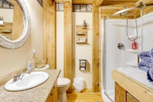 a bathroom with a toilet sink and a shower at 7 Mi to Glens Falls Peaceful Retreat with Game Room 