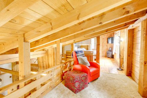a red chair in a room with wooden walls at 7 Mi to Glens Falls Peaceful Retreat with Game Room 