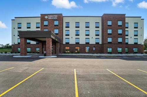 an empty parking lot in front of a building at Cobblestone Hotel & Suites - Bellefontaine in Bellefontaine