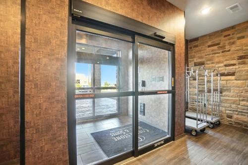 a room with a window with a view of a city at Cobblestone Hotel & Suites - Bellefontaine in Bellefontaine