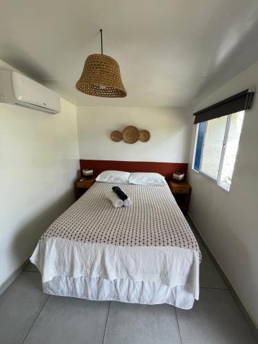 a bedroom with a bed with a stuffed animal on it at Maré suites in Fernando de Noronha