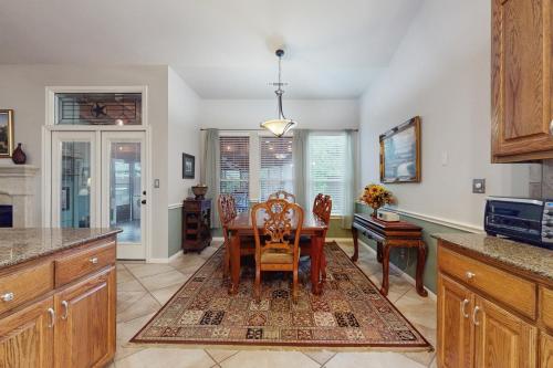 a kitchen with a table and chairs and a dining room at Pomegranate Leisure in Cedar Park