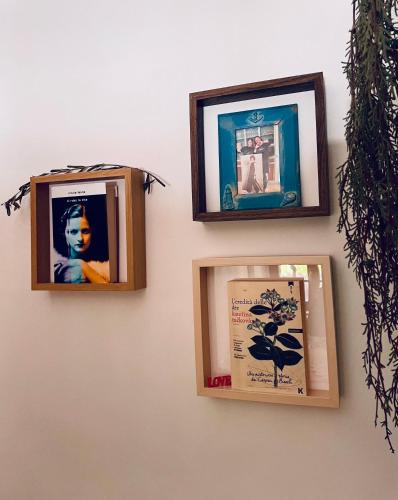 three pictures are hanging on a wall at Le Giuggiole in Tuscany in Usigliano